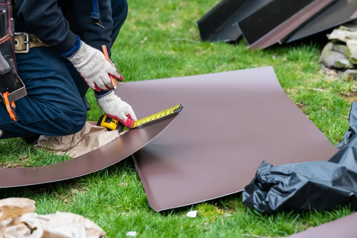 Roofers measuring roof shingles.